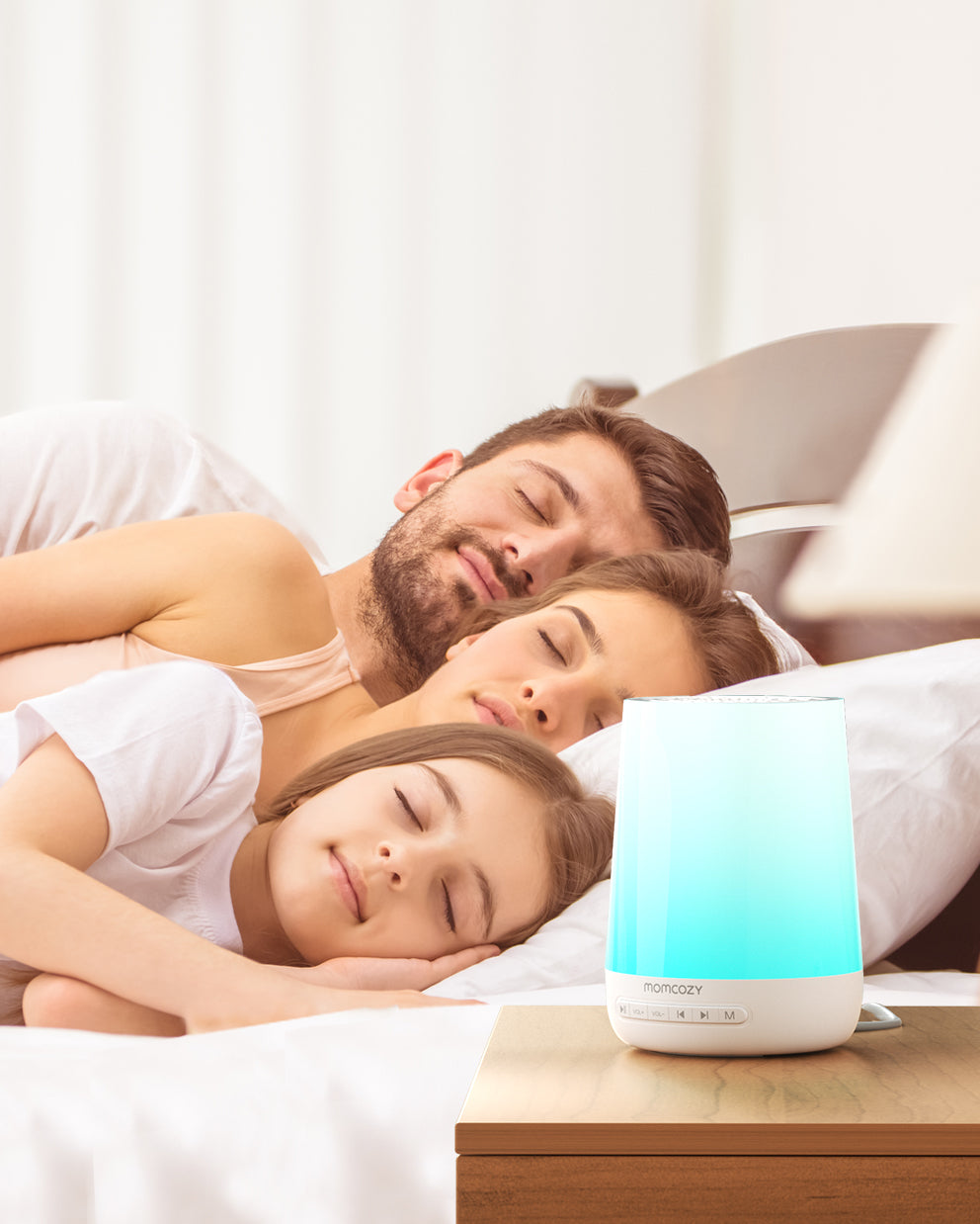 Smart Baby Sound Machine by Momcozy, with soft blue light, promoting peaceful sleep for a family of three.