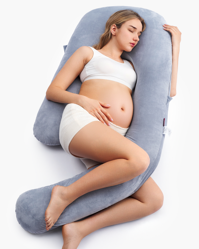 Translation missing: th.Pregnant woman resting on a grey Momcozy Dreamlign pregnancy pillow, providing support and comfort during sleep