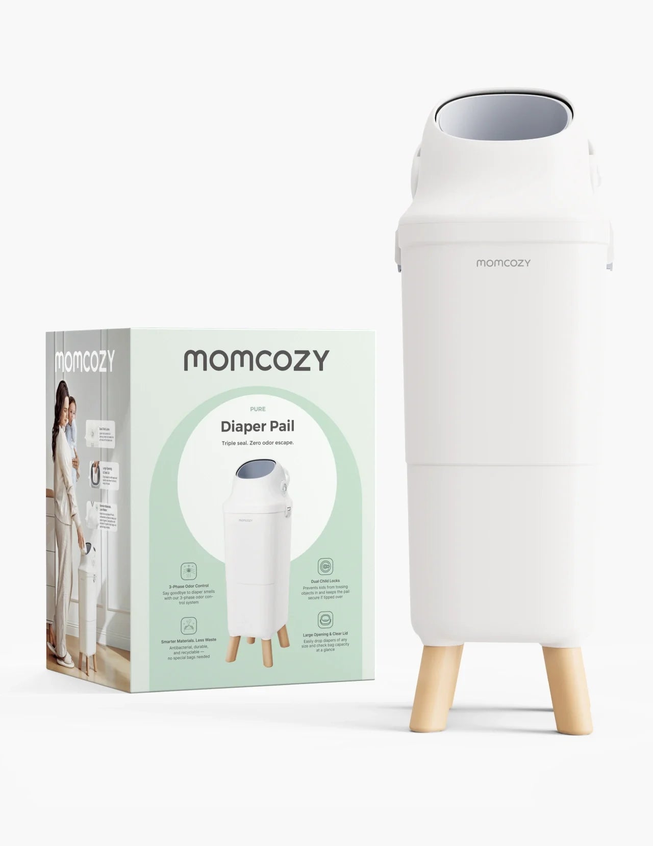 Momcozy Triple-Seal diaper pail in white with wood legs beside packaging
