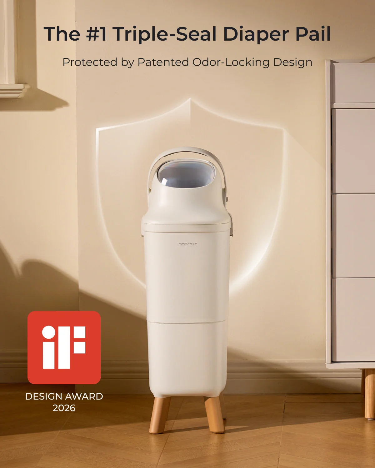 White Momcozy Triple-Seal diaper pail with wooden legs, shown with an iF Design Award 2026 logo