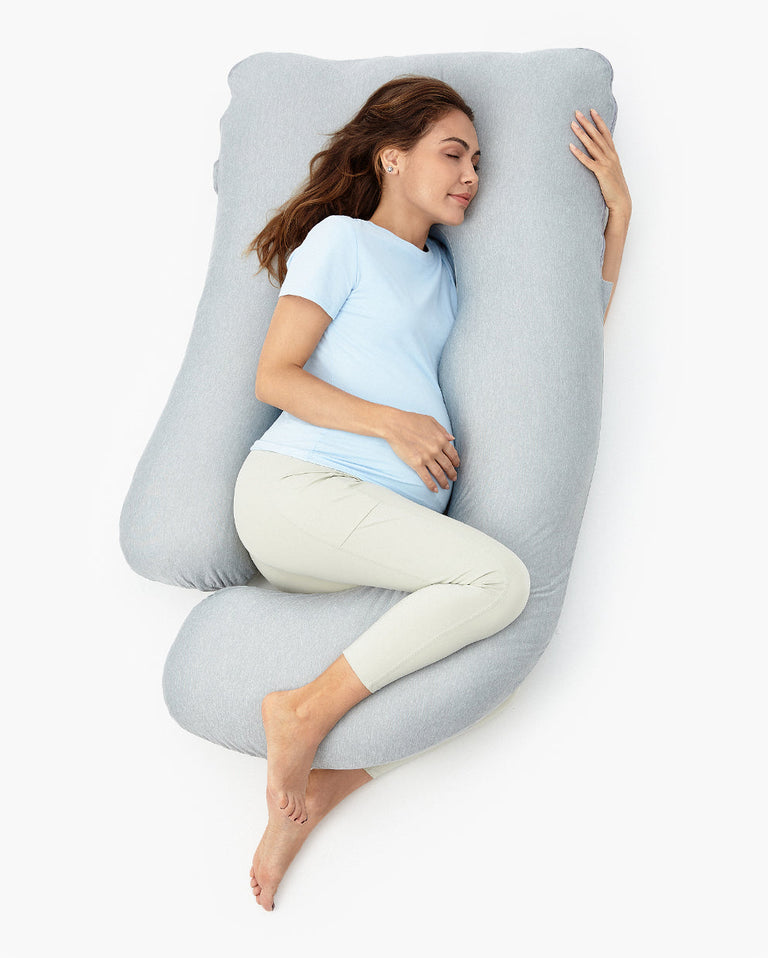 Translation missing: en.Pregnant woman resting on a light gray U-shaped maternity body pillow for pregnancy comfort and restful sleep